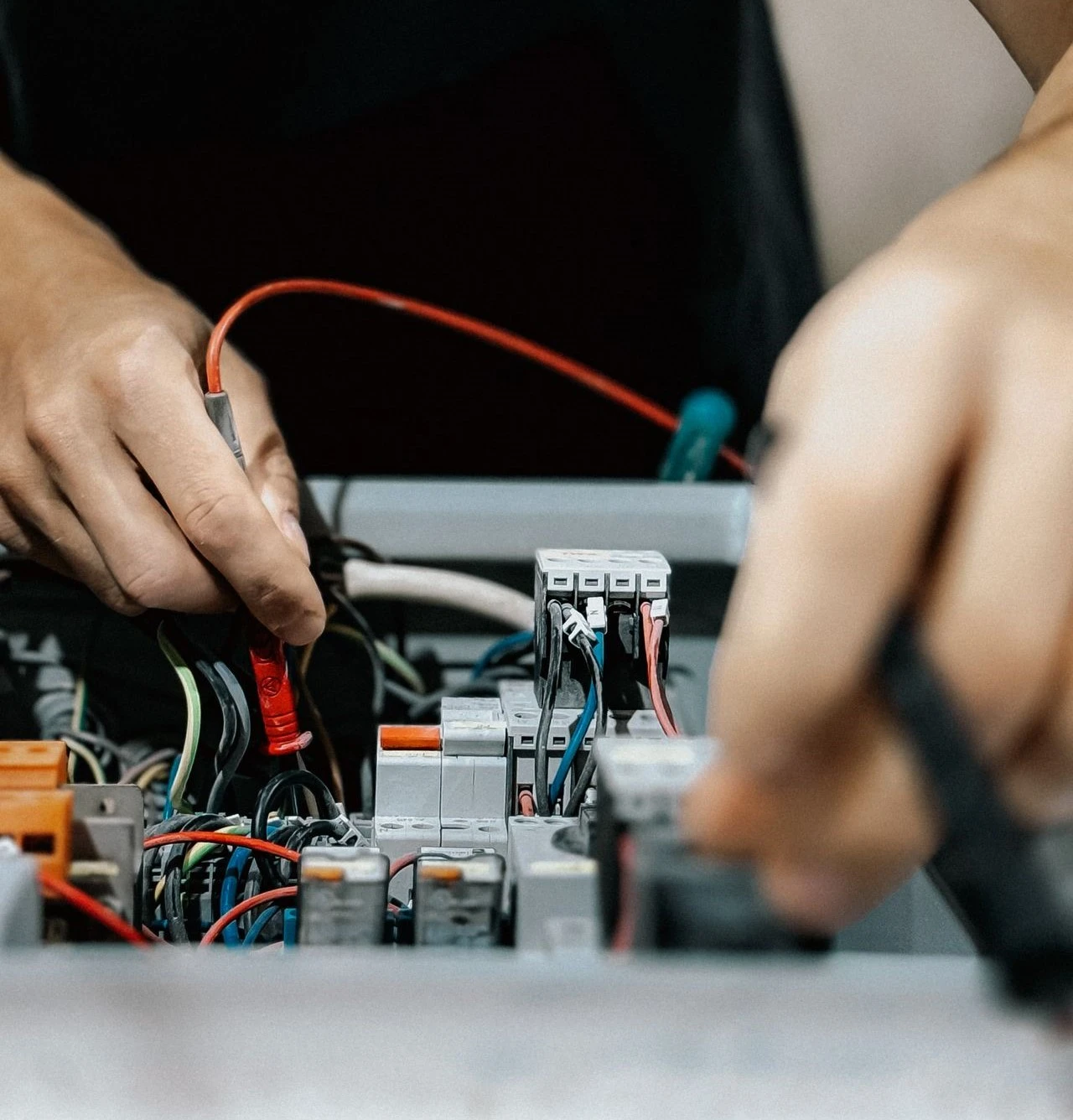 Licensed electrician repairing electrical circuit board