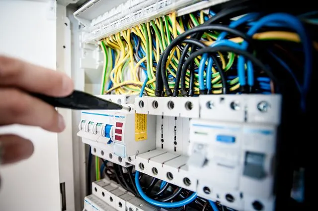 Residential electrician fixing an opened swithboard in resedential home