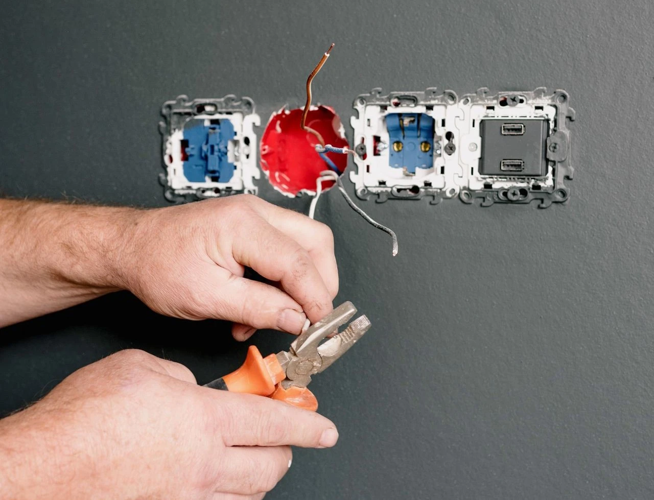 Electrician repairing a damaged outlet in a Round Rock home