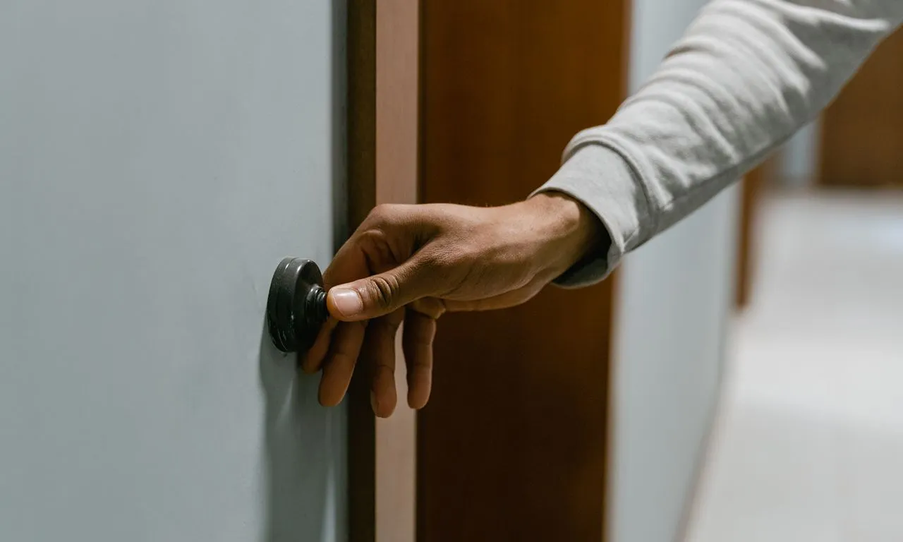 person ringing a door bell