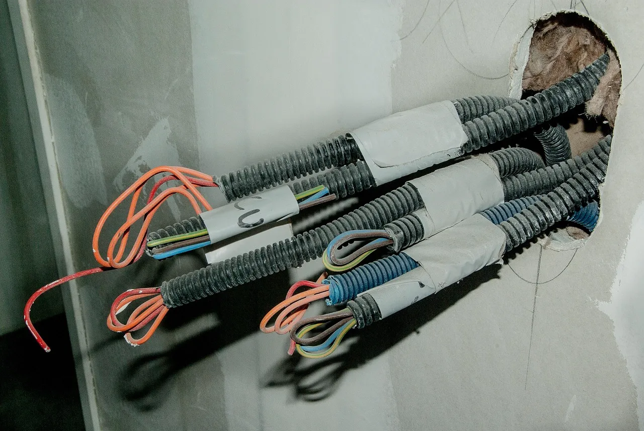 Storm damaged electrical wiring being inspected and repaired by an electrician